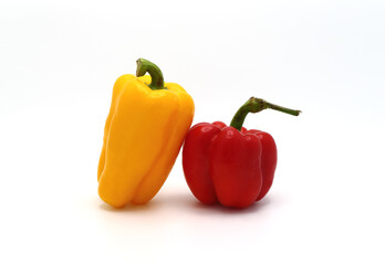 Two sweet peppers of yellow and red color on a light background. Natural product. Natural color. Close-up.