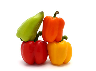 Four ripe sweet peppers on a light background. Red, yellow, green and orange. Natural product. Natural color. Close-up.