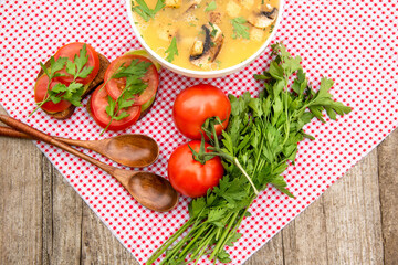 Home-made mushroom soup. Vegetarian lunch with a plate of mushroom soup and sandwiches with tomatoes and herbs.