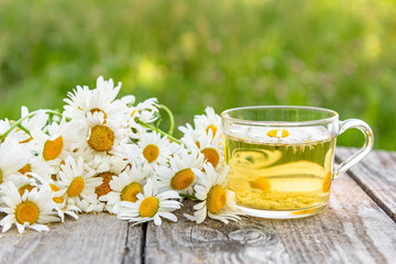 Chamomile tea in the fresh air. Useful soothing chamomile tea.
