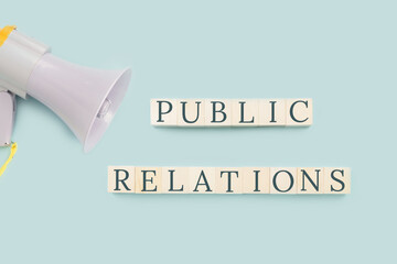 Public relations text concept. Building blocks with megaphone concept. Business or company...