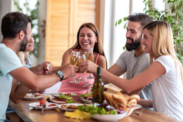 Group of friends have fun while have lunch together.