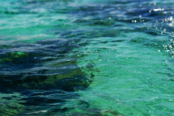 Closeup photo of beautiful tranquil blue green ocean water surface. Selective focus
