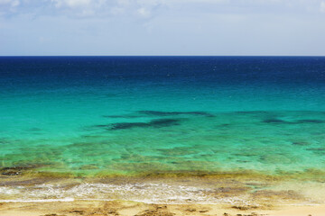 Fototapeta na wymiar Tropical beach, azure ocean water and blue sky. Paradise landscape.