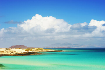 Tropical beach, azure ocean water and blue sky. Paradise landscape.