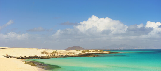 Tropical beach, azure ocean water and blue sky. Paradise landscape.