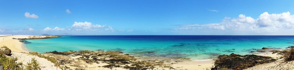 Tropical beach, azure ocean water and blue sky. Paradise landscape. Panorama