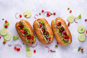 Hot dogs with sausage, sauces and vegetables