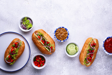 Hot dogs with sausage, sauces and vegetables