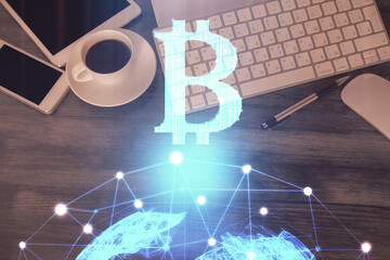 Double exposure of blockchain theme hologram over table with phone. Top view. Crypto technology...