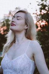 Portrait of a young beautiful blonde woman in the park.