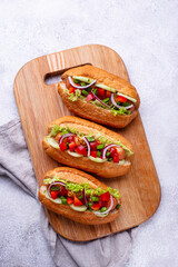 Hot dogs with sausage, sauces and vegetables