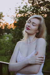 Portrait of a young beautiful blonde woman in the park.