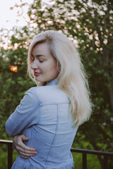 Portrait of a young beautiful blonde woman in the park.
