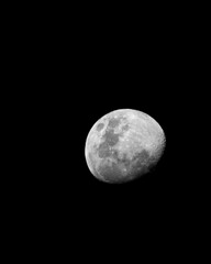 waxing gibbous moon over black