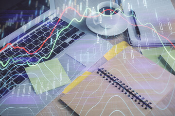 Multi exposure of forex graph drawing and desktop with coffee and items on table background. Concept of financial market trading