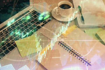 Multi exposure of forex graph drawing and desktop with coffee and items on table background. Concept of financial market trading