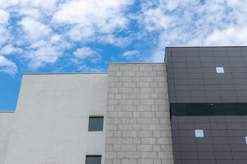 architecture simple background pattern exterior facade building design walls foreshortening from below with blue sky white clouds background space for your text