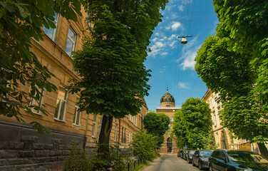 beautiful old city street without people here because of pandemic conditions summer clear weather day time walk site with green trees foliage and mosque landmark urban view