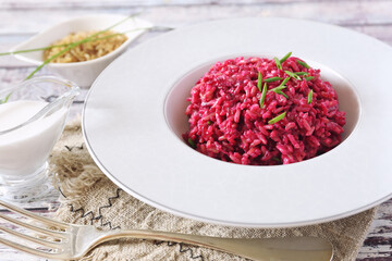 Pink rice. Beetroot risotto from brown rice with almond milk. Diet food.