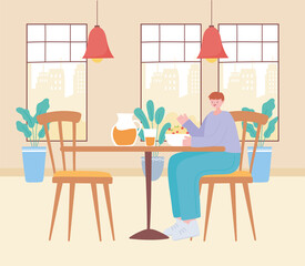 restaurant social distancing, young man eating in table, covid 19 pandemic, prevention of coronavirus infection