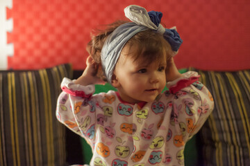 Baby poses with headscarf