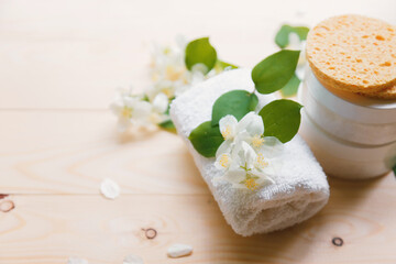 Fototapeta na wymiar Aroma Spa concept with jasmine flowers on a white wooden background, health care and spa.