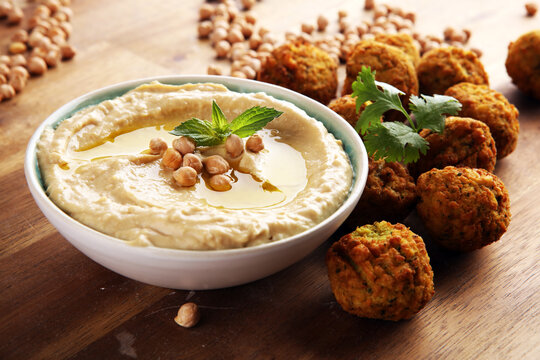 Traditional homemade hummus, falafel and chickpea on rustic table. Jewish Cuisine.