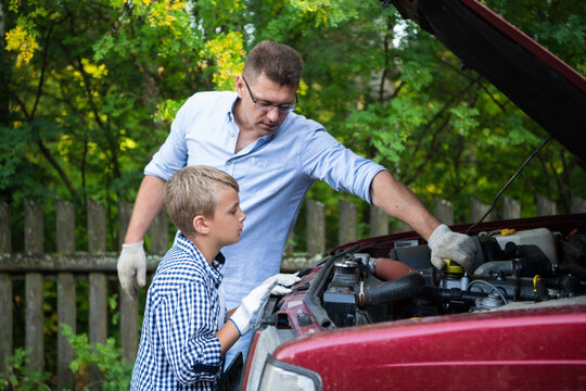 A father and son working together restoring an engine of their truck