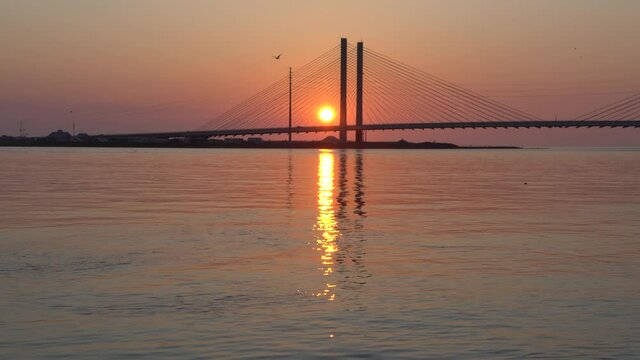 Silhouette of the Indian River Bridge during sunrise near Indian River Inlet, Delaware, U.S.A