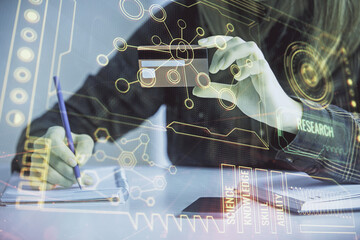 Double exposure of woman on-line shopping holding a credit card and data theme hologram drawing. E-commerce concept.