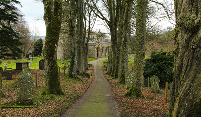 Fototapeta premium Small old church in the UK surrounded by trees