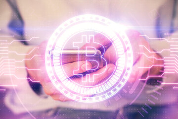 Double exposure of man's hands holding and using a phone and crypto currency blockchain theme drawing.