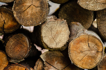 Naklejka premium Neatly stacked wooden logs. A lot of cut wood as a background
