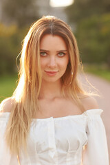 Naklejka premium Young pretty woman natural outdoor closeup face portrait. Beautiful girl with long hair
