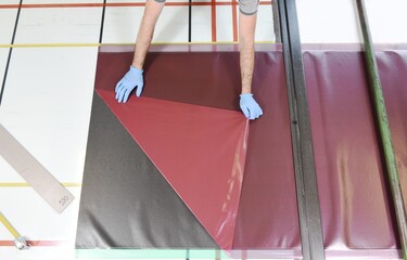 Professional worker with gloves manually realizes a component in real carbon fiber. Measurement and...