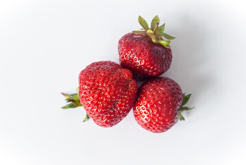 Eco or Bio Strawberry on White Background - Three Berries Tpo View Composition Isolated Close up Shot with Natural Light