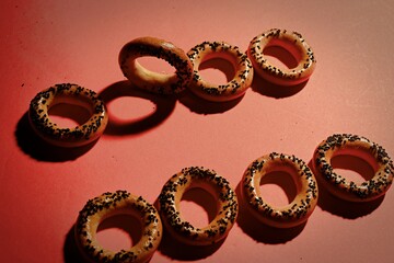 Bagel ornament with poppy seeds. Hard shadows.