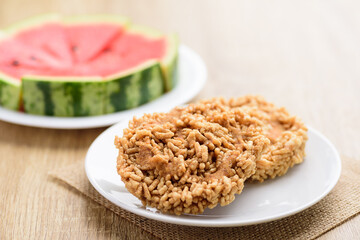 Local Thai snack (Khao Tan Nam Tangmo), deep fried crispy rice with cane sugar and watermelon