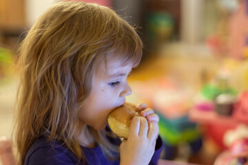 a little girl eating a donut