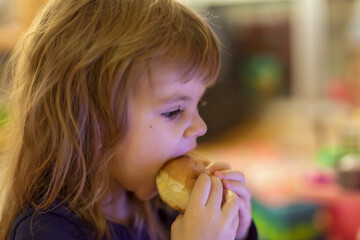 a little girl eating a donut