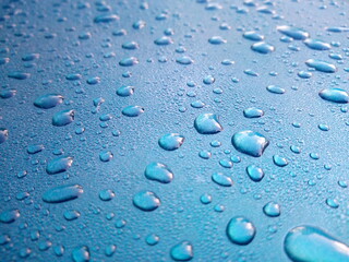Dew drops on the roof of the blue car Use as background.