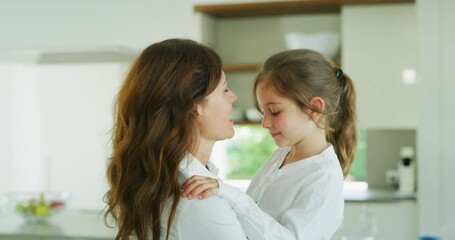 Authentic shot of an young happy smiling mother is enjoying time together with her cute little girl in the kitchen. A daughter giving hug to a mother, they are happy to spend time together. - Powered by Adobe