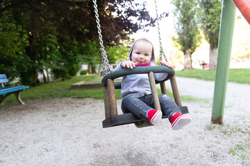 Child Swinging on Swing in a Park