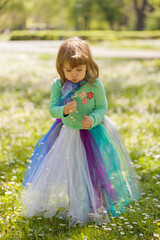 The girl blows into the dandelion