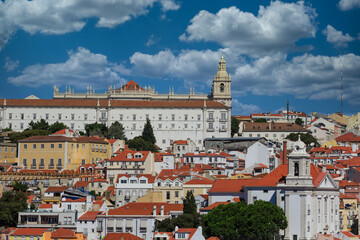 Colorful buildings and red tile rooftops on hills of Lisbon Portugal