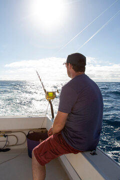  man doing sport fishing on a boat