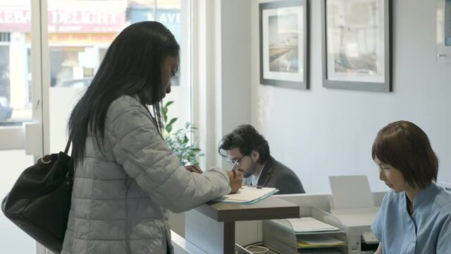 Patient filling out questionnaire at front desk