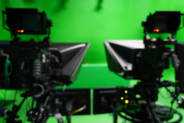 abstract blurred of broadcast camera in studio with virtual greenscreen at TV station.