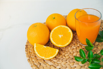 Freshly squeezed orange juice for health. Orange juice pouring pour oranges fruit fruits drink. Fresh orange juice with oranges fruit in kitchen.